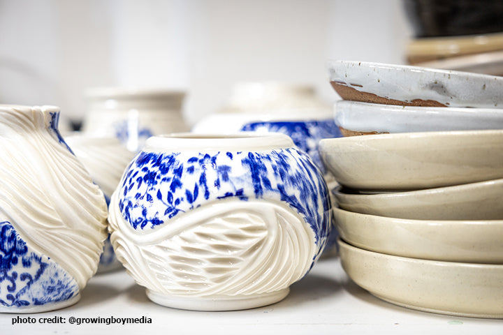 blue and white potter and stack of plates